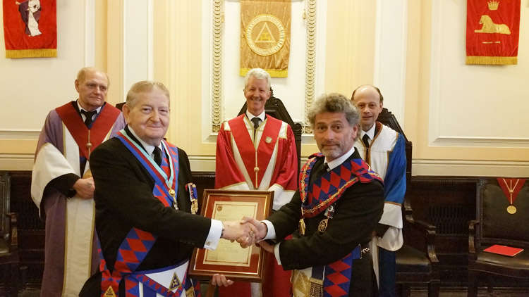 MetGInsp E.Comp Simon White presenting E.Comp Sid Goss with his Long Service Certificate